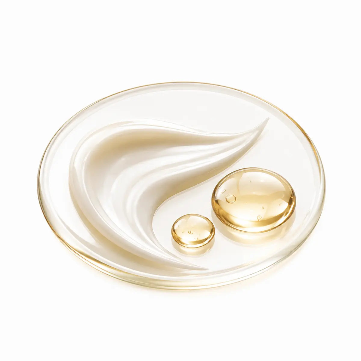 Silky cream and golden serum droplets on a glass dish